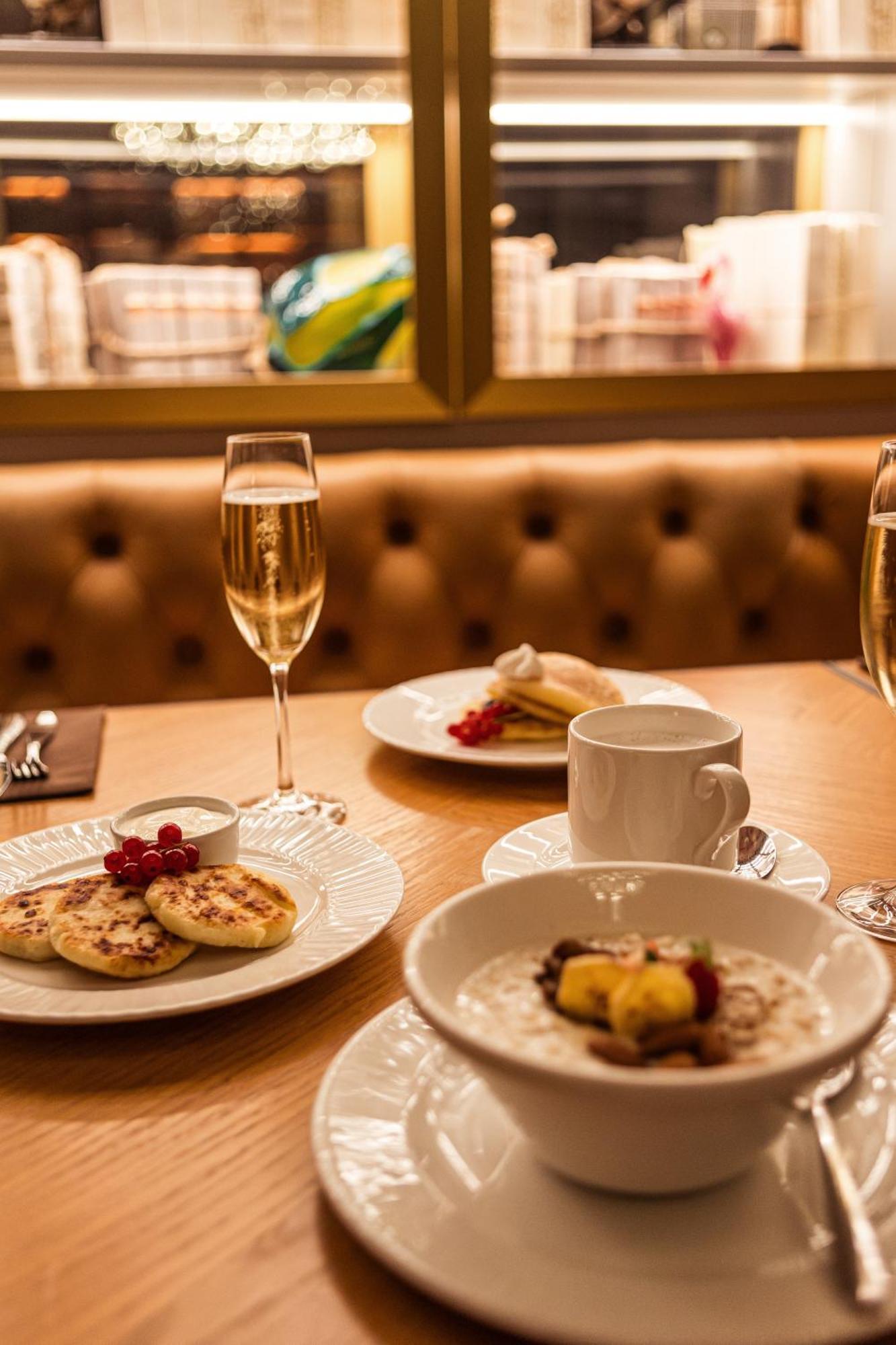 Grand Poet Hotel And Spa By Semarah Riga Exterior photo A glass of champagne